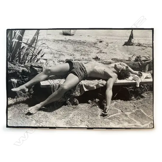 Unidentified photographer - Man sunbathing on bench, c.1975